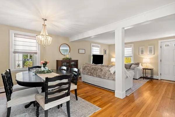 a living room with furniture a fireplace and a chandelier