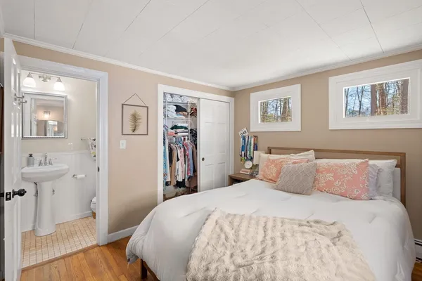 a bedroom with a bed and a painting on the wall