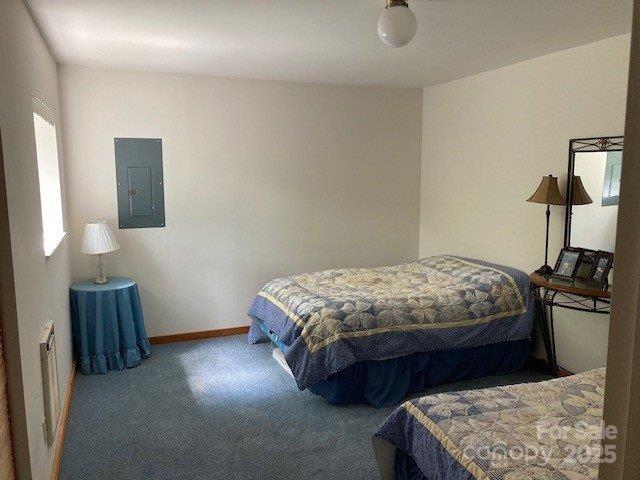 860 Pless Underwood Road Maggie Valley, NC 28751 - Photo 11 of 45 a bedroom with a bed and lamp