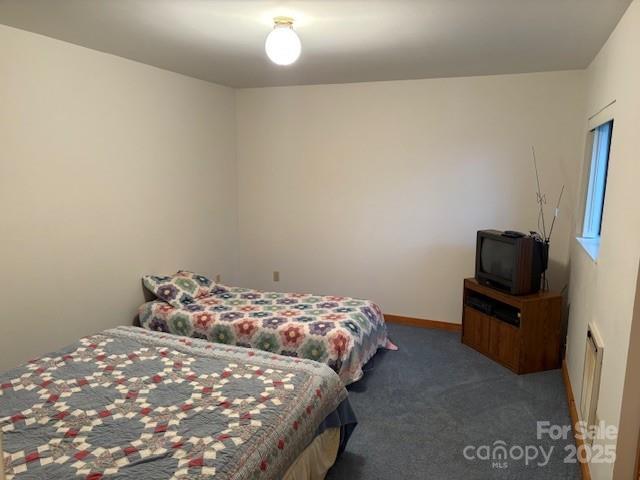 860 Pless Underwood Road Maggie Valley, NC 28751 - Photo 12 of 45 a bedroom with a bed and tv
