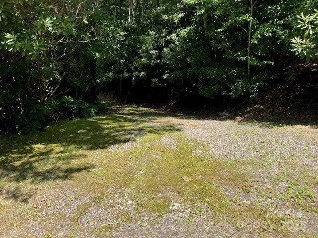 a backyard of a house with lots of green space and fountain