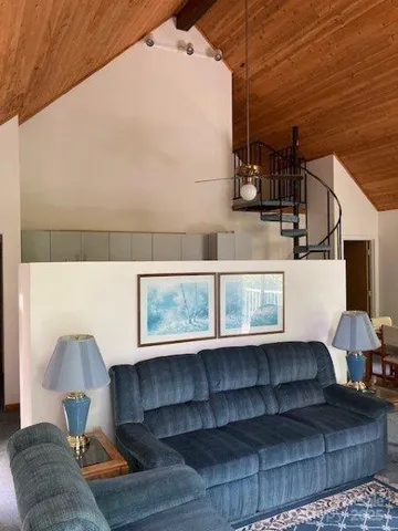 a room with furniture a air conditioner vent and a window