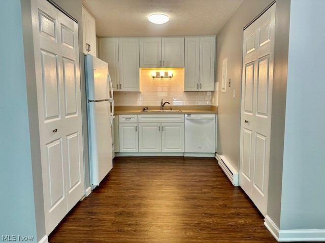 4376 Darrow Road, Unit 2 Stow, OH 44224 - Photo 7 of 26 Kitchen with white appliances, baseboard heating, a sink, white cabinets, and dark wood-style flooring