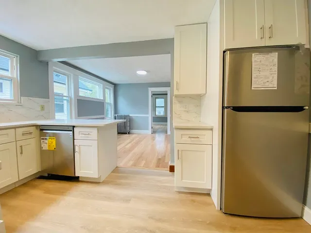 a view of a kitchen with an entryway and a wooden floors