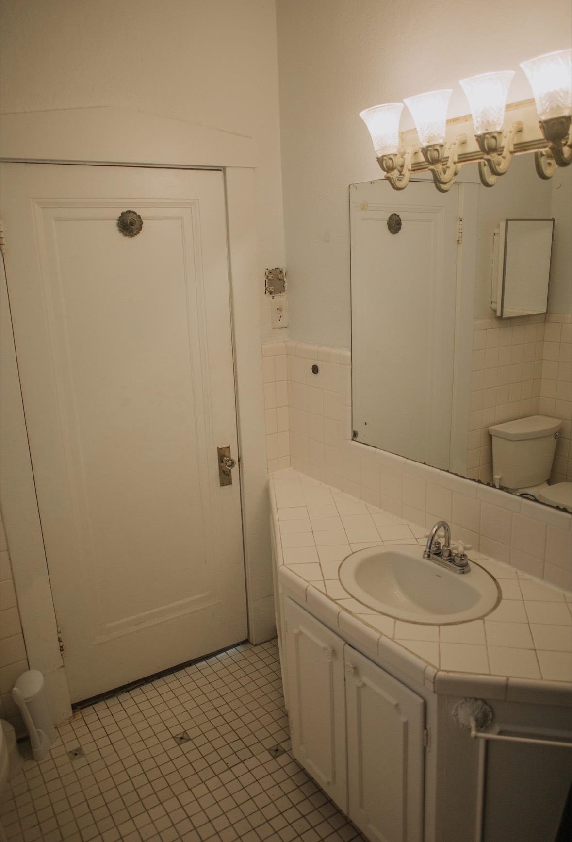 230 Lake Drive Ripley, TN 38063 - Photo 14 of 19 a bathroom with a sink and mirror
