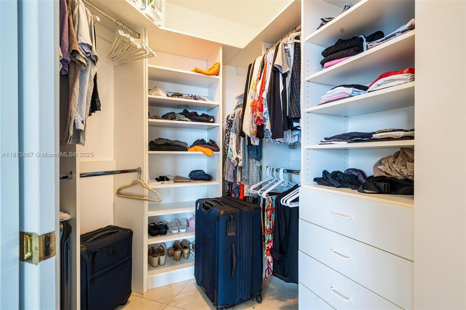 4779 Collins Avenue, Unit 2305 Miami Beach, FL 33140 - Photo 14 of 35 a view of walk in closet with clothes and shoes