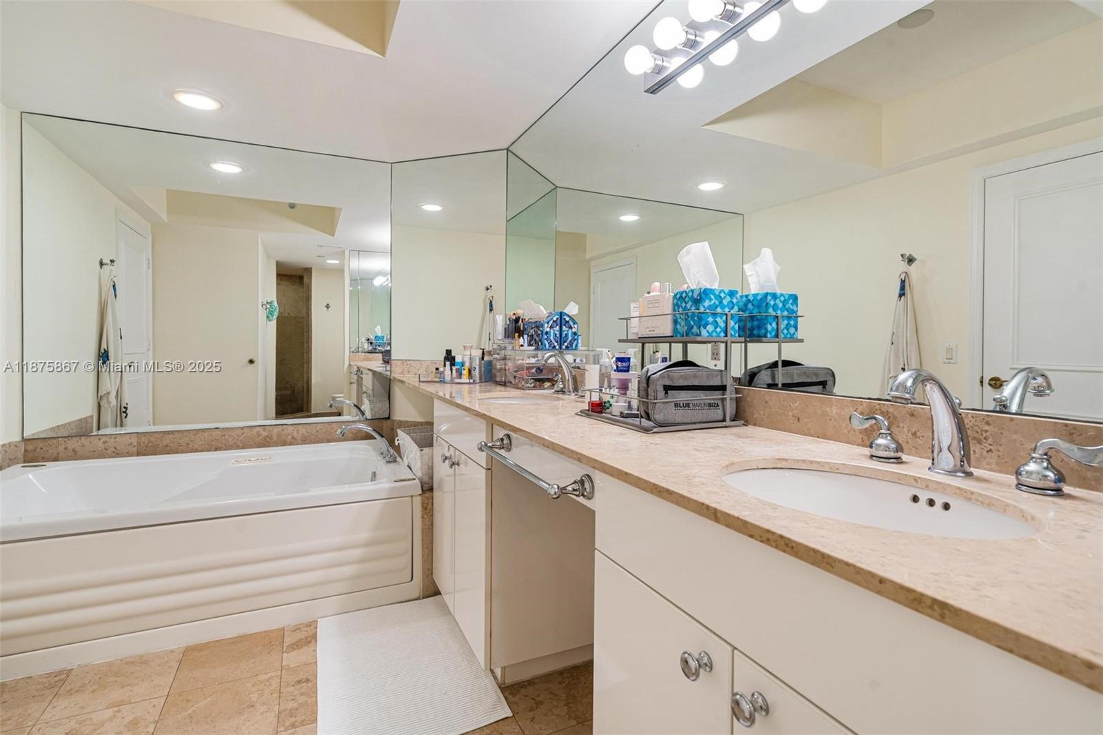 4779 Collins Avenue, Unit 2305 Miami Beach, FL 33140 - Photo 15 of 35 a bathroom with a sink double vanity and a mirror