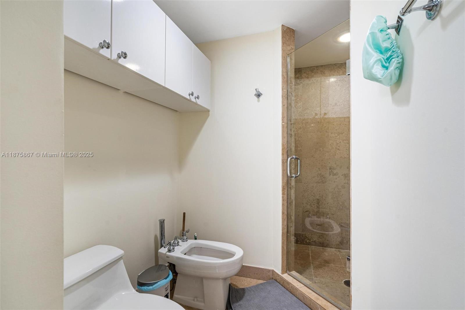 4779 Collins Avenue, Unit 2305 Miami Beach, FL 33140 - Photo 16 of 35 a bathroom with a sink toilet and shower