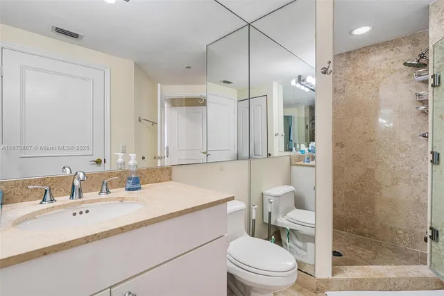 a bathroom with a toilet sink and shower
