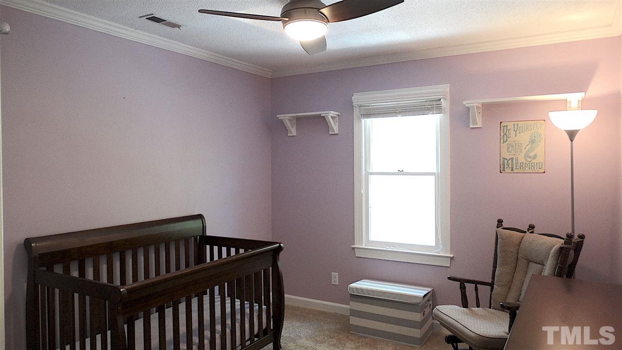 6812 Chasewick Circle Raleigh, NC 27615 - Photo 19 of 30 a bedroom with a bed and a window