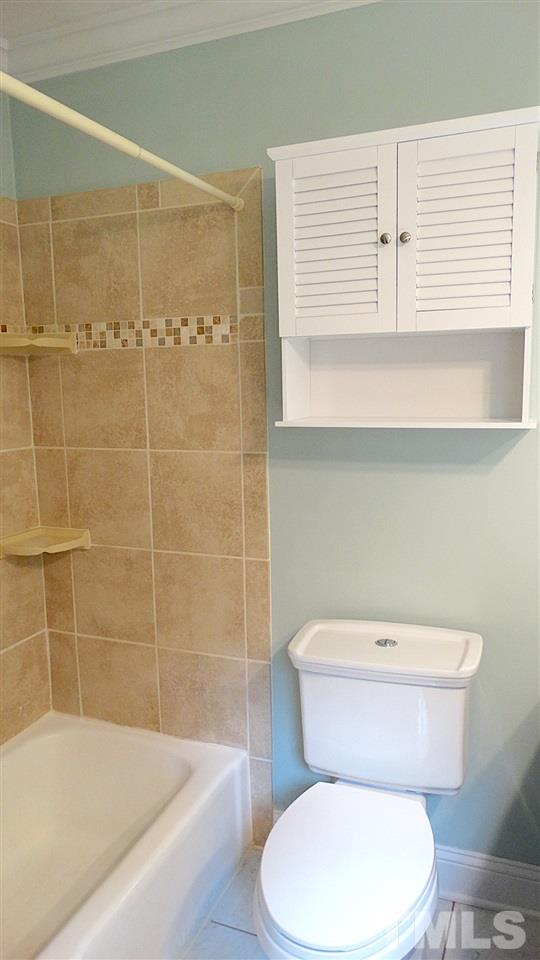 6812 Chasewick Circle Raleigh, NC 27615 - Photo 22 of 30 a white toilet sitting next to a bathroom sink and tub