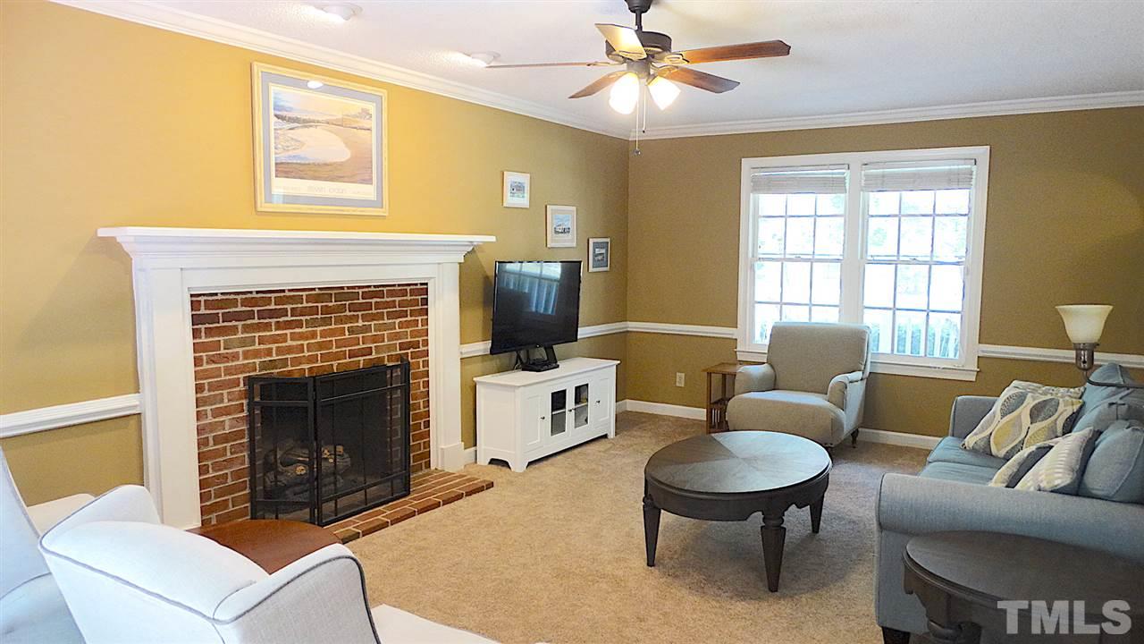 6812 Chasewick Circle Raleigh, NC 27615 - Photo 4 of 30 a living room with furniture a window and a fireplace