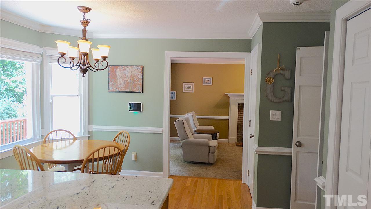 6812 Chasewick Circle Raleigh, NC 27615 - Photo 5 of 30 a living room with furniture and a chandelier
