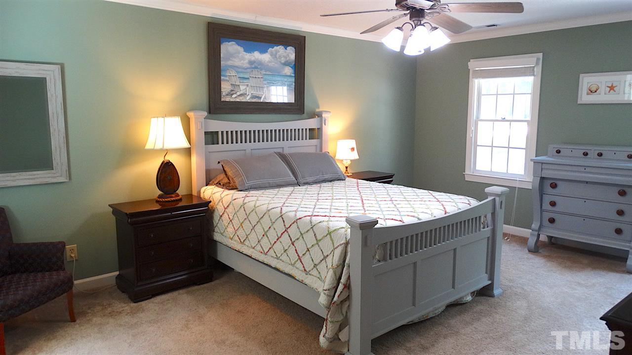 6812 Chasewick Circle Raleigh, NC 27615 - Photo 6 of 30 a bedroom with a bed and window