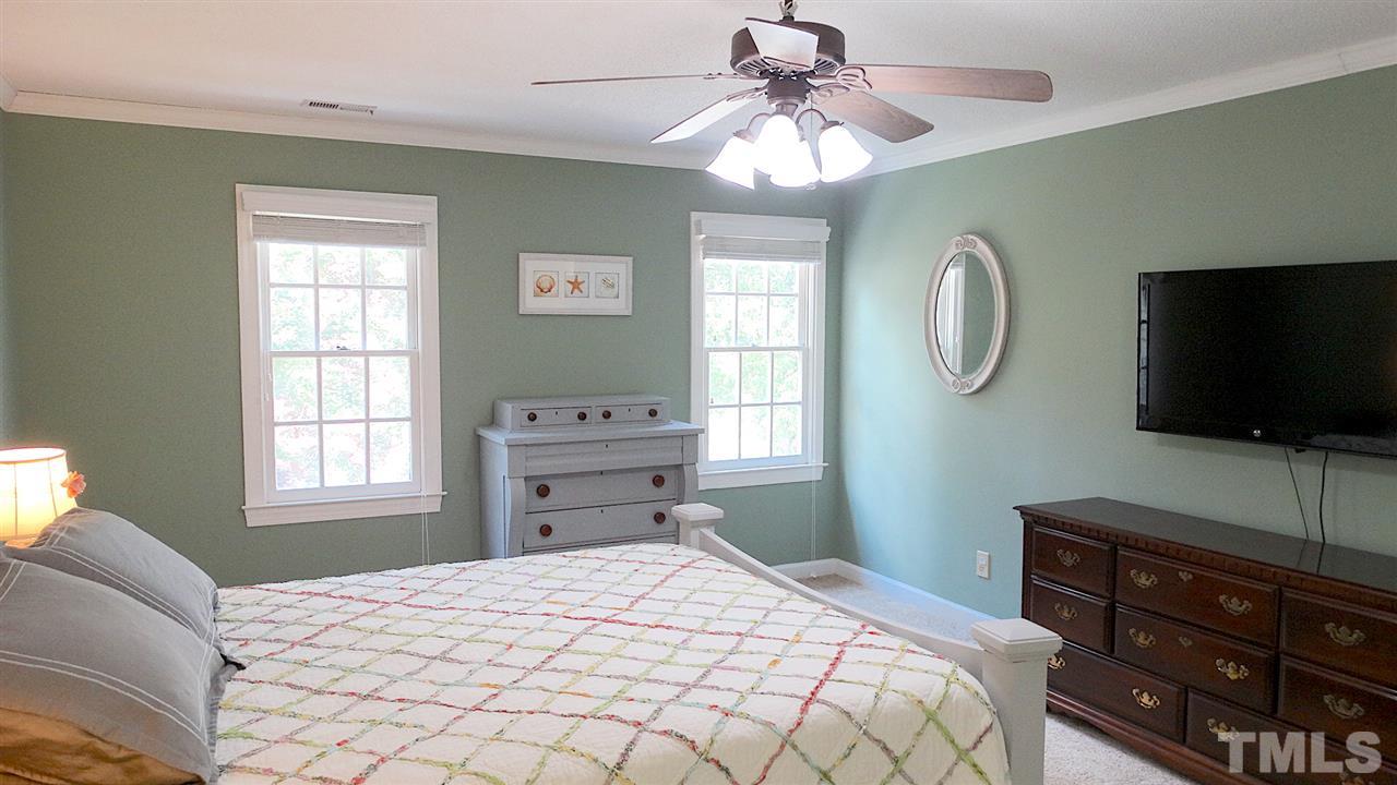 6812 Chasewick Circle Raleigh, NC 27615 - Photo 7 of 30 a bedroom with a bed and a flat screen tv