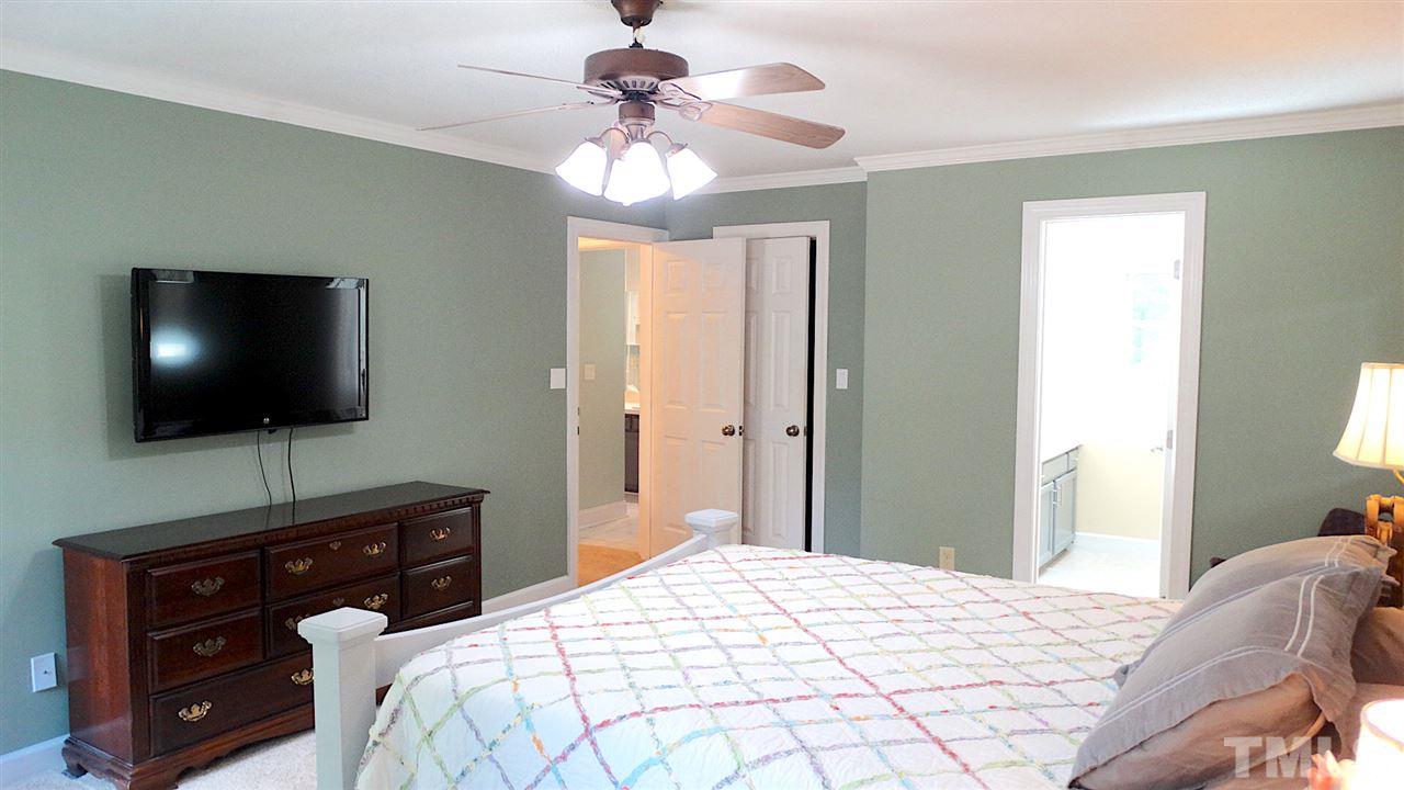 6812 Chasewick Circle Raleigh, NC 27615 - Photo 8 of 30 a bedroom with a bed and a flat screen tv