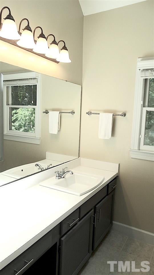6812 Chasewick Circle Raleigh, NC 27615 - Photo 9 of 30 a bathroom with a sink and a mirror