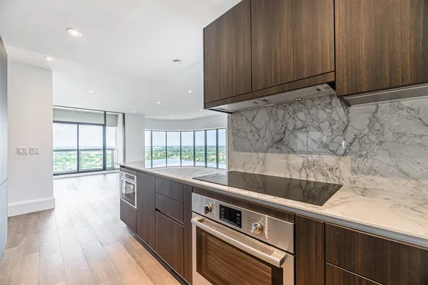 a view of a kitchen with a sink and wooden floor