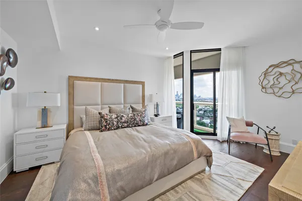 a bedroom with a large bed and a window