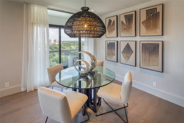 a view of a dining room with furniture wooden floor and chandelier