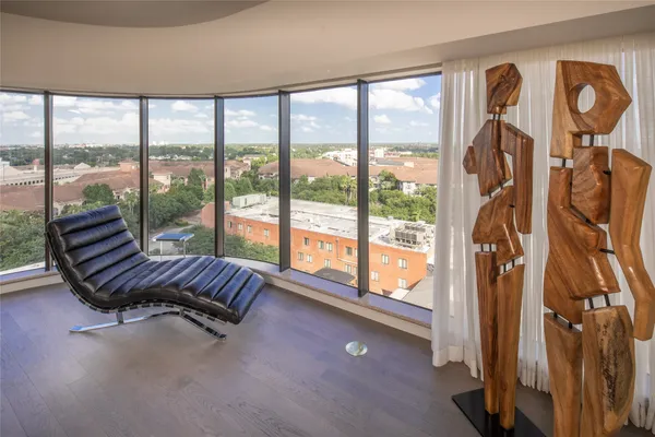a living room with furniture and a floor to ceiling window