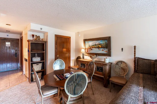 a living room with furniture a rug and a window