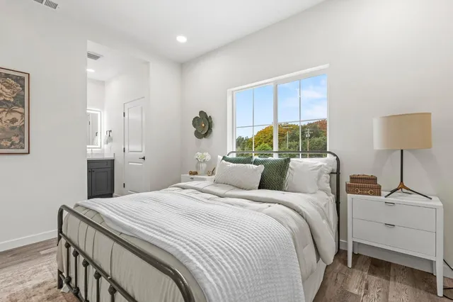 a bedroom with a large bed and a chandelier
