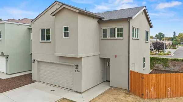 a view of a house with wooden fence