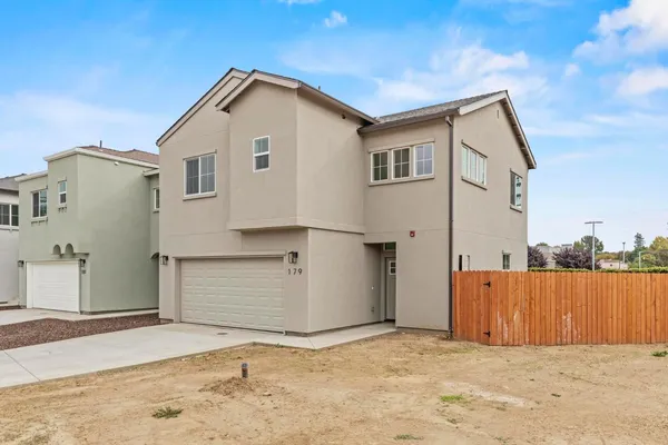 a view of a house with a wooden fence
