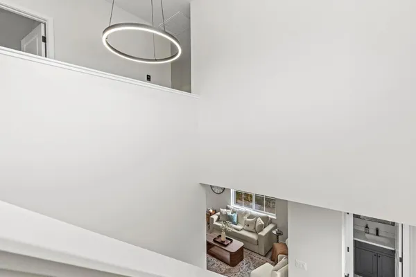 a view of a hallway with wooden floor and staircase
