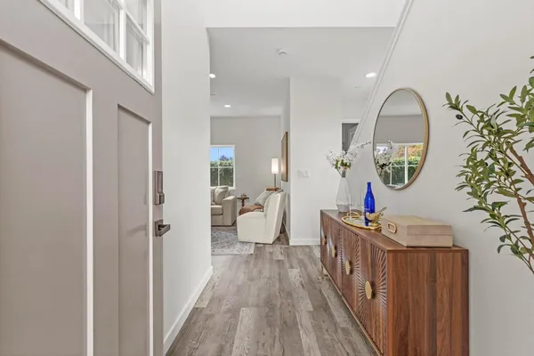 a view of a hallway with wooden floor and entryway