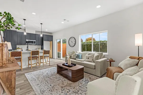 a kitchen with a dining table chairs and a chandelier