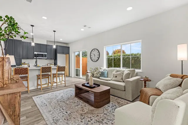 a kitchen with a dining table chairs and a chandelier