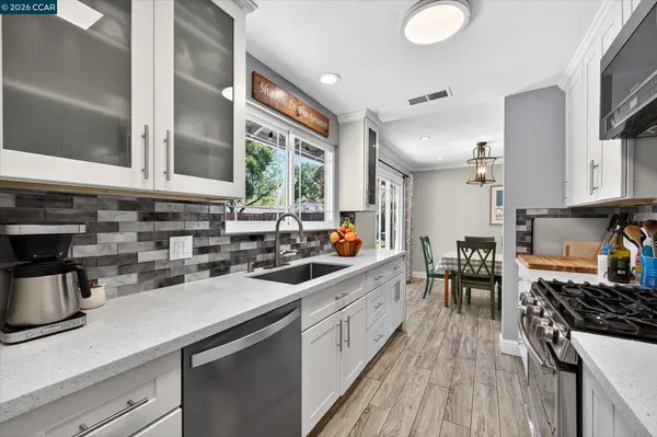 a kitchen with a sink stove and cabinets