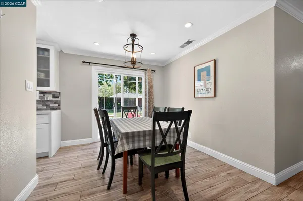 a view of a dining room with furniture window and wooden floor