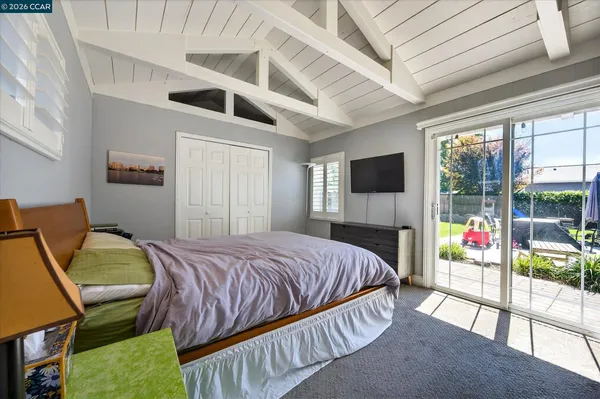 a bedroom with a bed and a tv