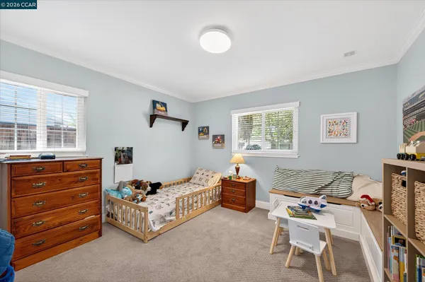 a bedroom with furniture and a window