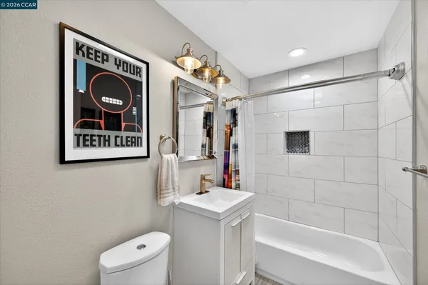 a bathroom with a sink a mirror and a bathtub