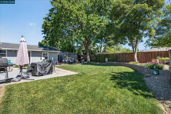 a view of a house with backyard and sitting area