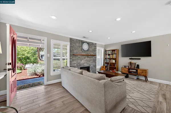 a living room with fireplace furniture and a flat screen tv