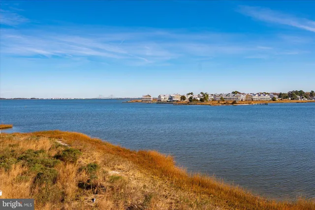a view of a livingroom with wooden floor and a large window