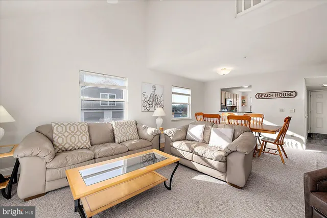 a bedroom with a bed a chandelier and a dresser