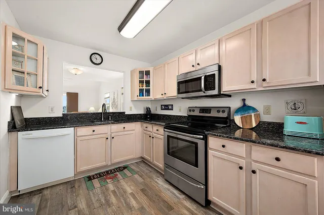 a bedroom with two beds and painting on the wall