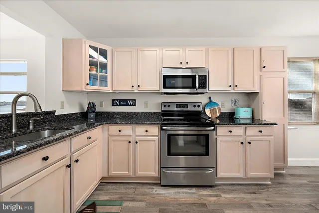 a bedroom with two beds and a flat screen tv
