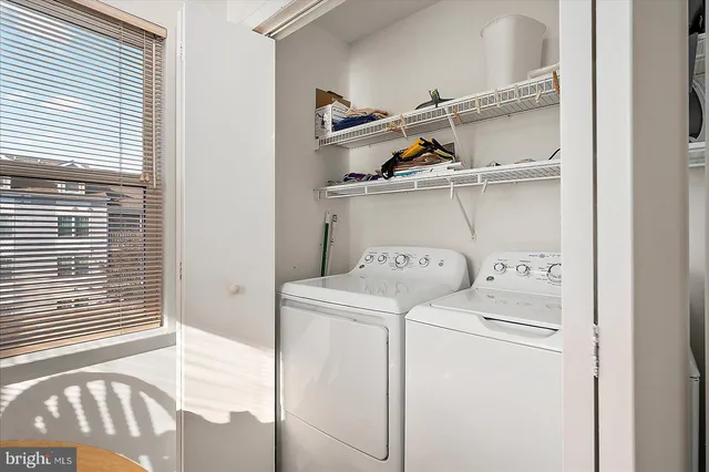 an aerial view of ocean and residential houses with outdoor space