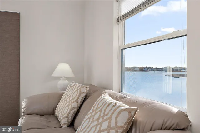 a view of a balcony with wooden floor chairs and wooden fence