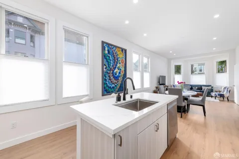 a kitchen that has a sink a stove counter top space and a window