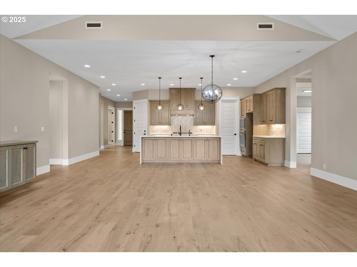 16221 Northeast 180th Street Brush Prairie, WA 98606 - Photo 18 of 43 a large room with chandelier and wooden floors