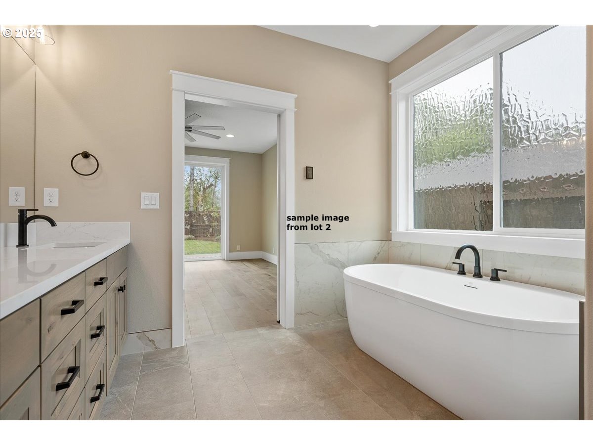 16221 Northeast 180th Street Brush Prairie, WA 98606 - Photo 20 of 43 a spacious bathroom with a bathtub sink and mirror