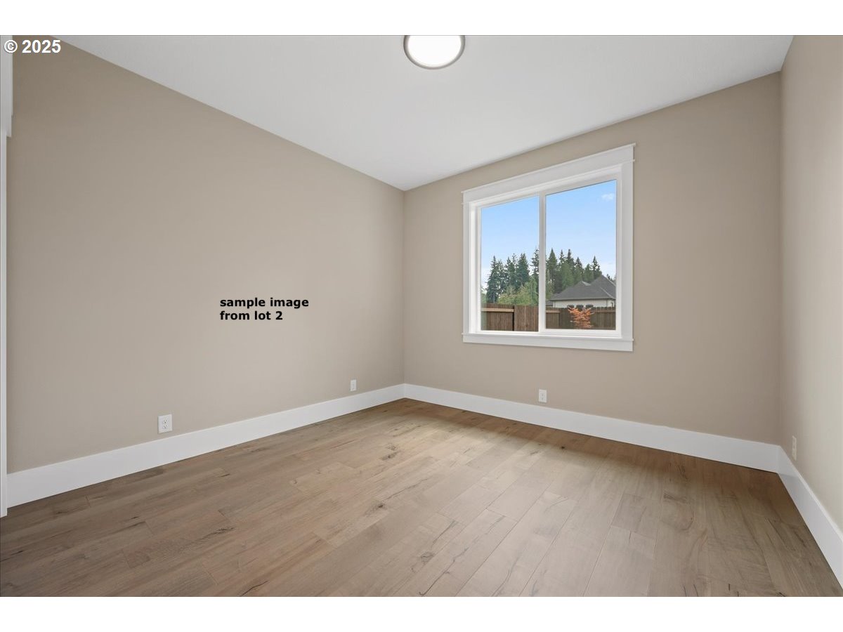 16221 Northeast 180th Street Brush Prairie, WA 98606 - Photo 22 of 43 a view of an empty room with wooden floor and a window